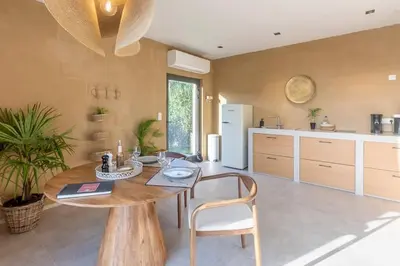 a kitchen with a wooden table and a dining room at Gite SIWA pour 2 personnes in Verviers