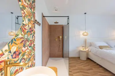 a bedroom with a shower and a bed and a bathroom at Gite Olea de deux personnes in Basse Tribomont