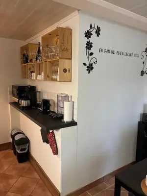 a kitchen with a counter in a room at Vakantiehuis chaletje in Lanaken