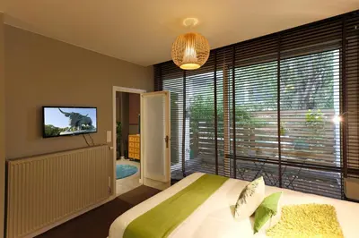 a bedroom with a bed and a large window at Aparthotel Liège in Liège