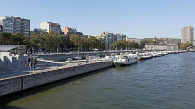a group of boats docked at a marina in a city at Aparthotel Liège in Liège