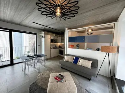 a living room with a couch and a table at lOFT 202 in Liège