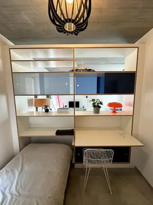 a bedroom with a desk and a bed in a room at lOFT 202 in Liège