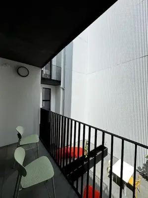 a room with a balcony with two chairs and a couch at lOFT 202 in Liège
