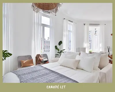 a white bedroom with a large bed with white pillows at La bulle bohème - Entièrement neuf, près de Spa in Verviers