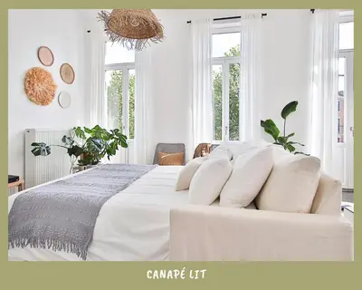 a white bedroom with a large bed with white pillows at La bulle bohème - Entièrement neuf, près de Spa in Verviers