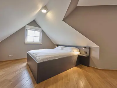 a bedroom with a bed in the attic at Bigaro 1 in Heers