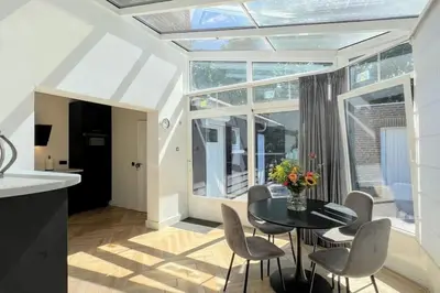 a kitchen and dining room with a table and chairs at Vakantiewoning De Merode in Lanaken