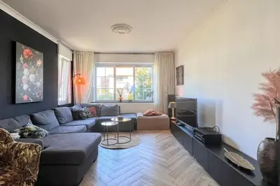 a living room with a couch and a table at Vakantiewoning De Merode in Lanaken