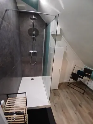 a bathroom with a shower with a glass wall at Vakantiehuis 2 Wheels 2 Relax in Wellen