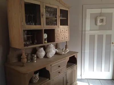 a wooden cabinet with vases on it in a room at De Brugdraaier - The Bridge Turner in Neerpelt