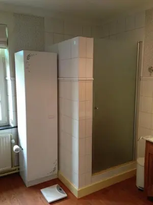a kitchen with a white refrigerator in a room at De Brugdraaier - The Bridge Turner in Neerpelt
