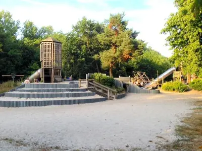 a set of stairs in a park with a playground at De Brugdraaier - The Bridge Turner in Neerpelt