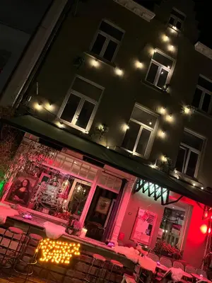a restaurant with tables and chairs at night at The House Of Jack's in Hasselt