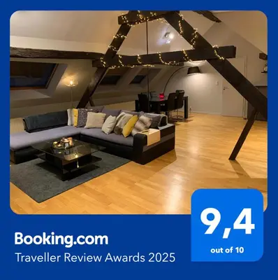 a living room with a couch and a table at Lovely loft for romantic getaway or family trip in Chaudfontaine