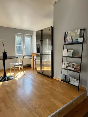 a room with a refrigerator and a table and a desk at Lovely loft for romantic getaway or family trip in Chaudfontaine