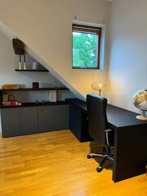 a office with a desk with a chair and a window at Lovely loft for romantic getaway or family trip in Chaudfontaine