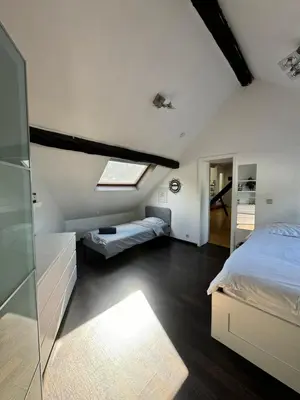 a attic bedroom with a bed and a skylight at Lovely loft for romantic getaway or family trip in Chaudfontaine
