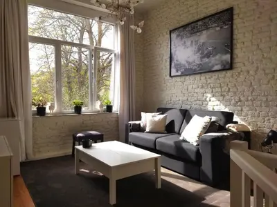 a living room with a couch and a coffee table at Louvrex 78 in Liège