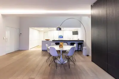 a kitchen and dining room with a table and chairs at Louvrex 78 in Liège