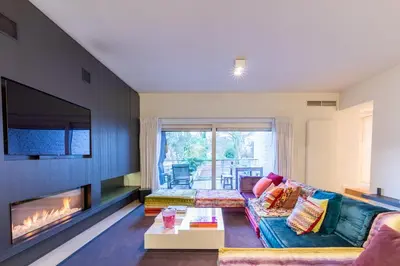 a living room with a couch and a fireplace at Louvrex 78 in Liège