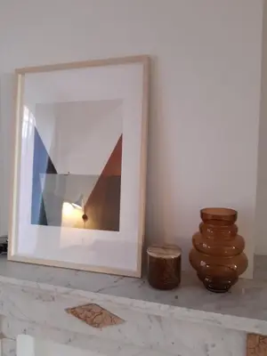 a picture frame sitting on a counter next to a vase at Atelier 27, Duplex with terrace and beautiful view in Liège