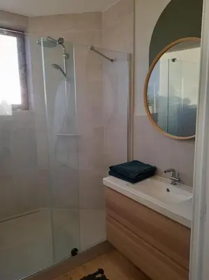 a bathroom with a shower and a sink and a mirror at Atelier 27, Duplex with terrace and beautiful view in Liège