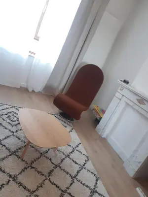 a chair and a stool in a living room at Atelier 27, Duplex with terrace and beautiful view in Liège