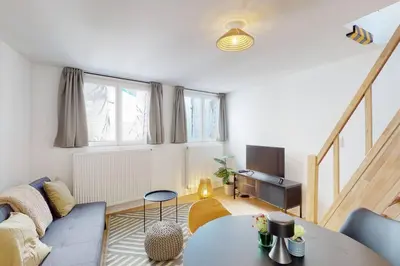 a living room with a couch and a table at House W 35 in Liège