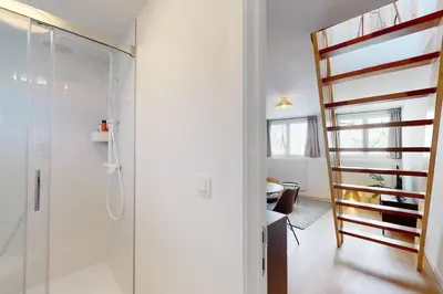 a bathroom with a walk in shower and a staircase at House W 35 in Liège