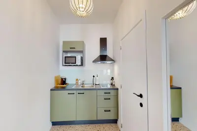 a kitchen with a sink and a microwave at House W 35 in Liège