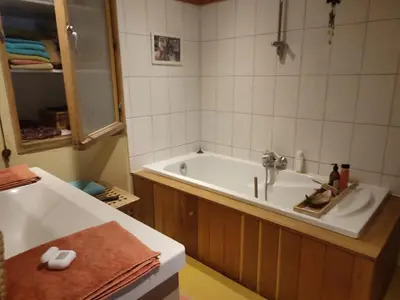 a bathroom with a bath tub and a sink at Chez Marie in Liège