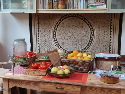 a table with baskets of fruits and vegetables on it at Chez Marie in Liège