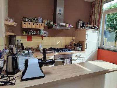 a kitchen with a white refrigerator and a counter top at Chez Marie in Liège