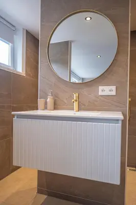 a bathroom with a sink and a mirror at Wellnesshuisje Pocono cabin in Lanaken