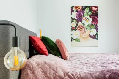 a bedroom with a bed with red pillows and a painting at 8P 4B Lanaken Retreat: Swimming Pool Jacuzzi and Sauna in Lanaken