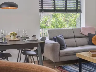a living room with a couch and a table at De Eekhoorn in Zutendaal