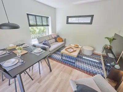 a living room with a table and a couch at De Eekhoorn in Zutendaal