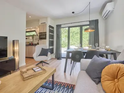 a living room with a couch and a table at De Eekhoorn in Zutendaal