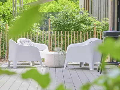 a group of white chairs sitting on a patio at De Eekhoorn in Zutendaal