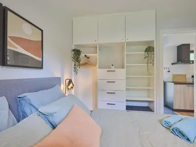 a bedroom with a bed and a closet at De Eekhoorn in Zutendaal