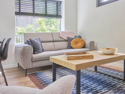 a living room with a couch and a coffee table at De Eekhoorn in Zutendaal