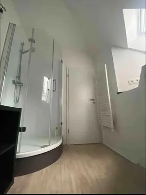 a bathroom with a shower and a glass shower stall at Petit Château in Eupen