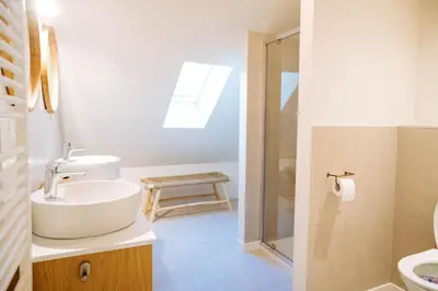 a white bathroom with a sink and a shower at Sweet Coffee Stay in Hasselt