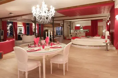 a dining room with a table and a bedroom at Studio Le Baiser d'Angeli in Ensival