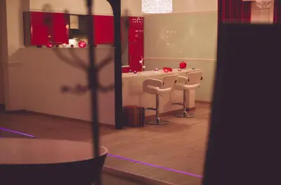 a room with a table and two stools in it at Studio Le Baiser d'Angeli in Ensival