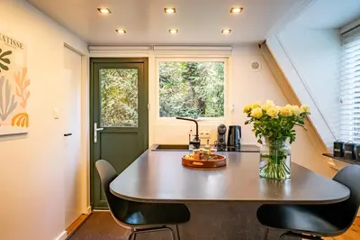 a tiny house with a table and chairs at Boshuisje Rekem - Ignis in Lanaken