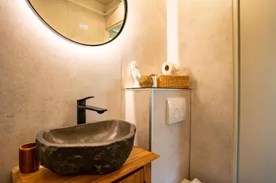 a bathroom with a black sink and a mirror at Boshuisje Rekem - Lotus in Lanaken