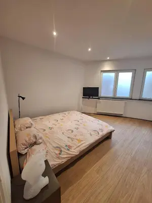 a bedroom with a bed in a room with windows at Peace and quiet in Liège, private room and bathroom in Liège