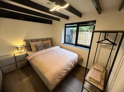 a bedroom with a large bed and a window at Etwee Vakantiehuis in Lanaken